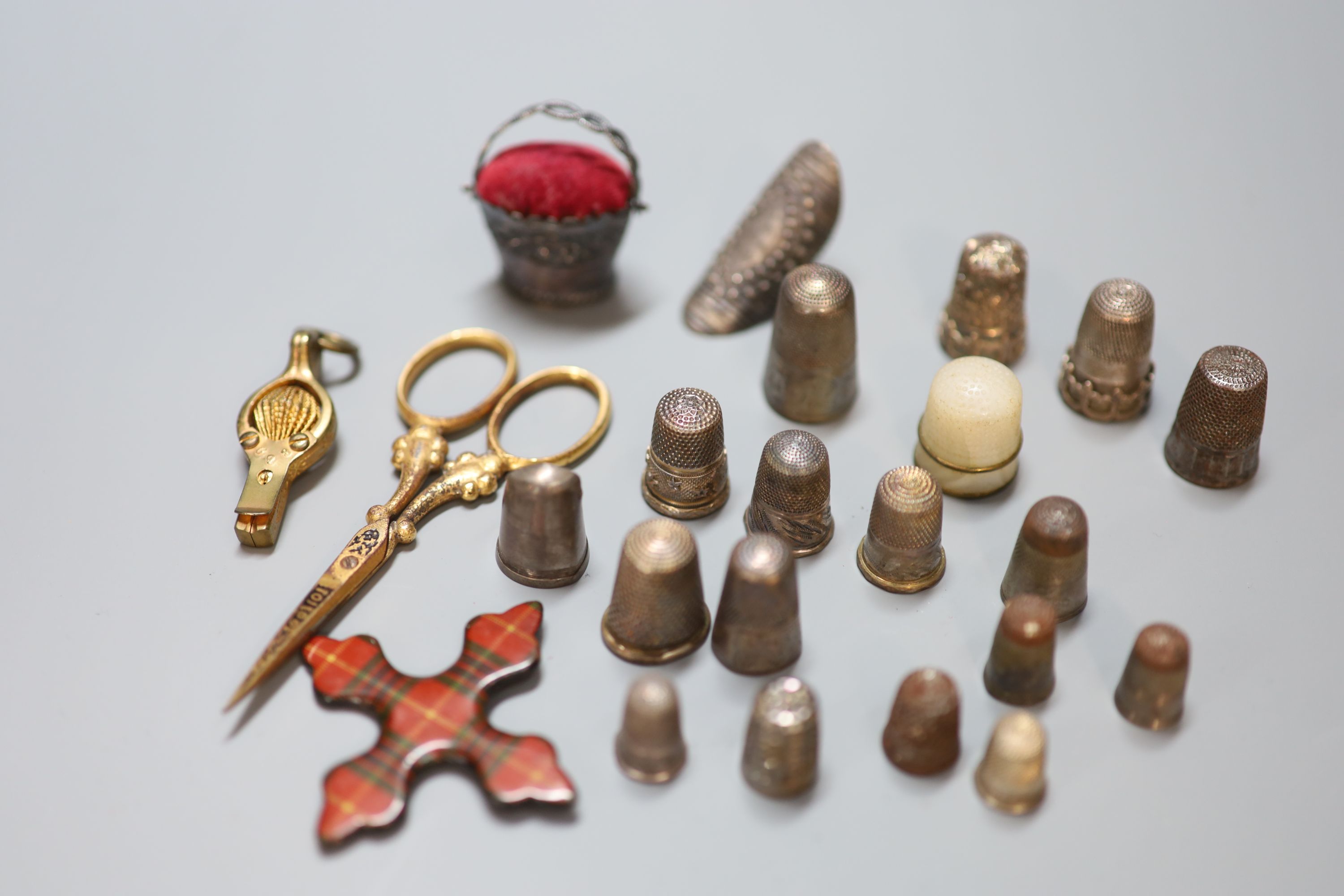 A collection of assorted thimbles and other sewing accessories